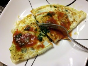 Spinach omelet with salt, pepper and picante sauce